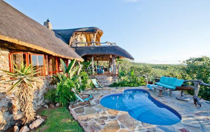 Thatched lodge with swimming pool