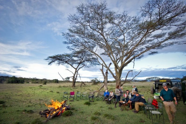 people sitting around camp fire in Kenya