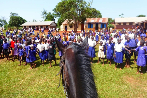 Horse gazing at children in front of a rural African School