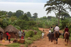 Horseback riders through rural African Village