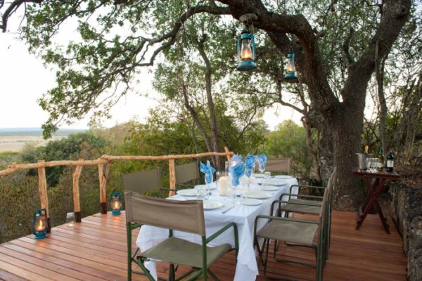 dining area on wooden deck under trees