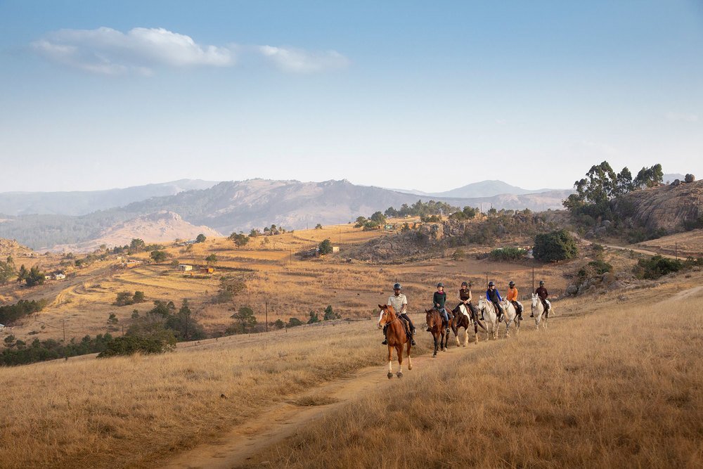 Horse riding through Africa farmland