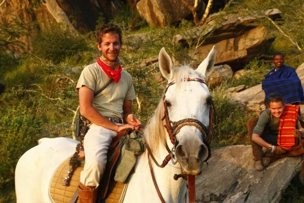Smiling man on white horse