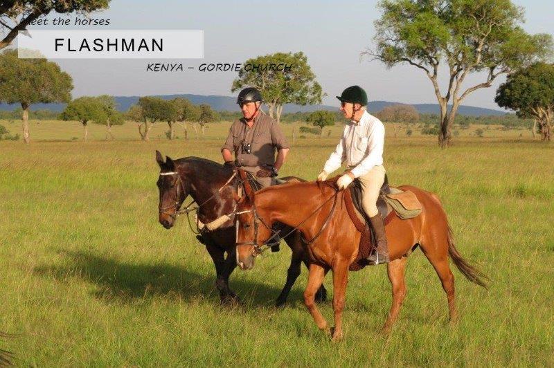 two men riding horses in Kenya savannah