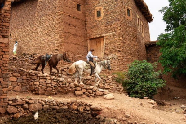 Horse riding through rural Moroccan village