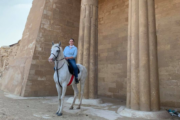 Girl on horse in front of Egyptian temple