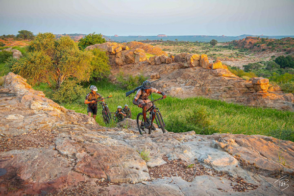 Cycle up rocky hills in Tuli