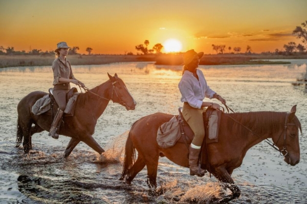 Horse riding at sunset at Cha Cha Metsi in the Okanvango Delta
