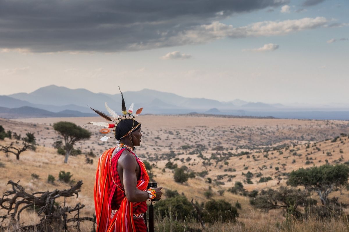 maasai tribesman in traditional clothing overlooking the plains and valleys of kenya