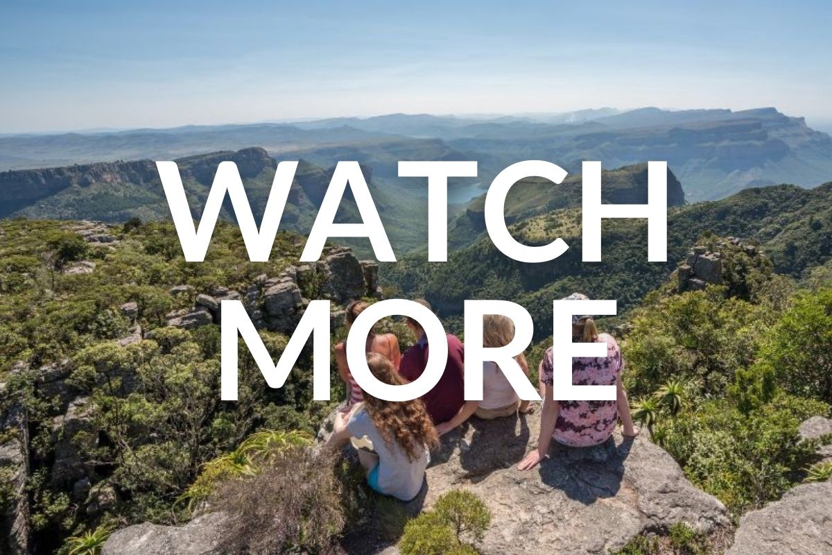 5 girls sitting on a rocky outcrop at the top of a hill overlooking the gorge spread out below them