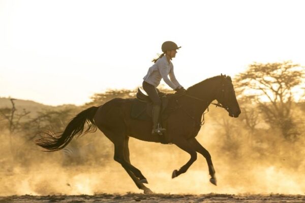 House in the Wild (43) Girl galloping on horseback in the Masai Mara at House in the Wild, Kenya